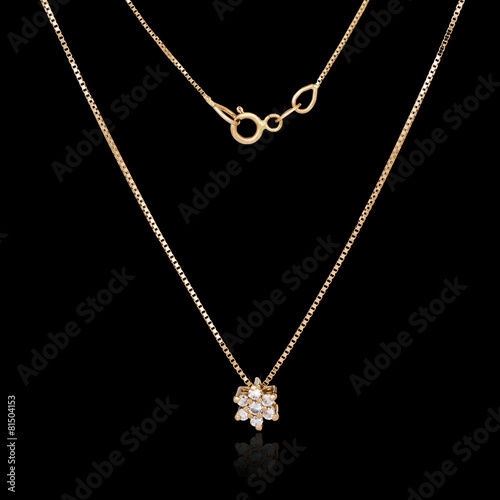 Golden necklace isolated on black background