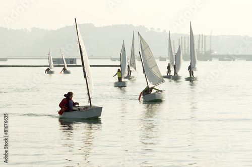 children return to navigate in their optimist and 4.70 sailboats