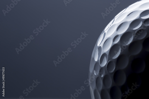 Stylish golf ball isolated on empty dark blue background.