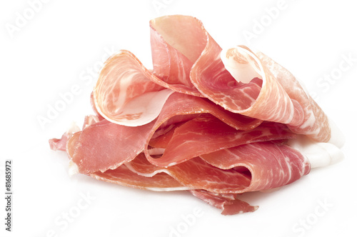 Italian prosciutto crudo ,raw ham leg sliced on white