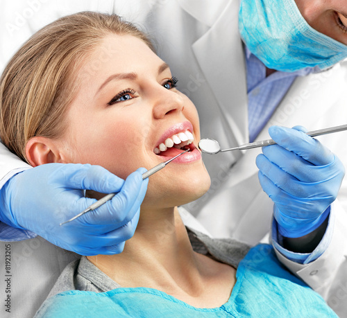 Dental health. Male dentist curing a female patient