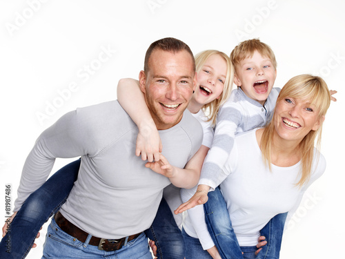 Parents giving piggyback ride to children