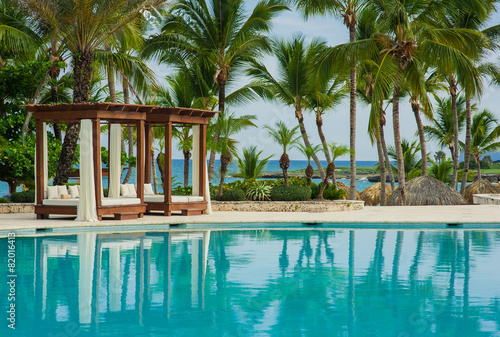 Swimming Pool at tropical beach - summer vacation background.