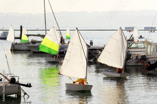 children learn to sail on optimist sailboat in Galicia Spain