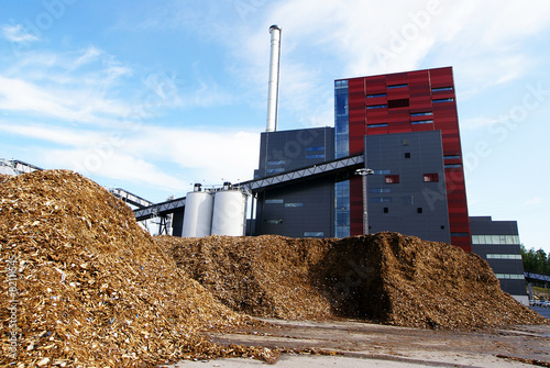 bio power plant with storage of wooden fuel (biomass) against bl