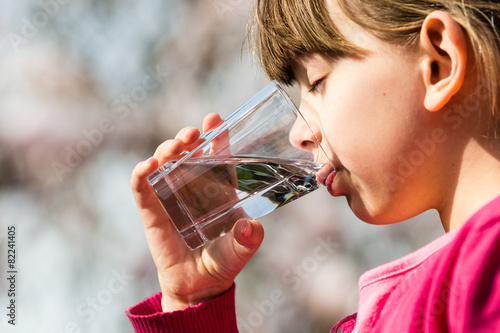 Girl drinking water from glass