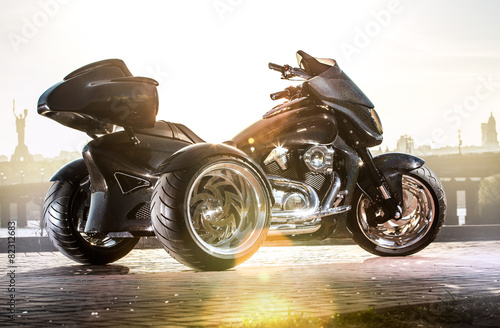 Black trike standing on the light street