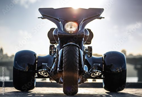 Black trike standing on the light street