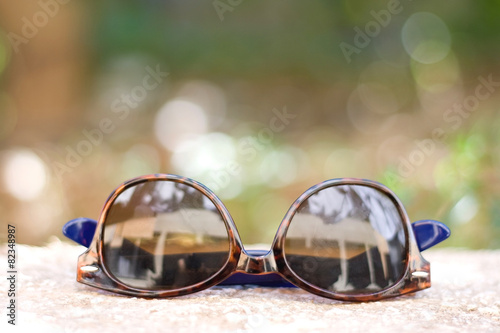 Brown round sunglasses outdoor, in summer. Selective focus.