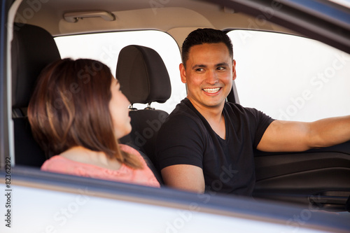 Young Hispanic couple in a car