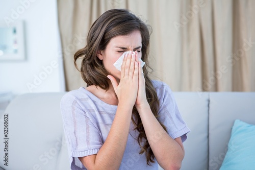 Sick woman blowing her nose