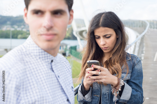 Woman distracted looking at her smart phone