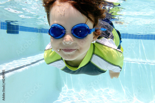 Child Swimming in Pool Underwater