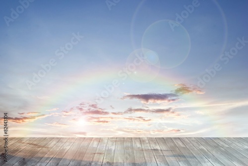 old wooden texture and rainbow with lens flare in blue sky