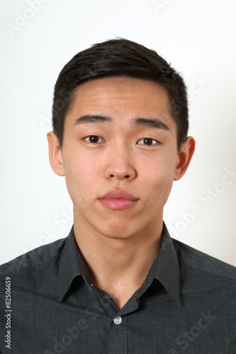 Romantic young Asian man looking at camera