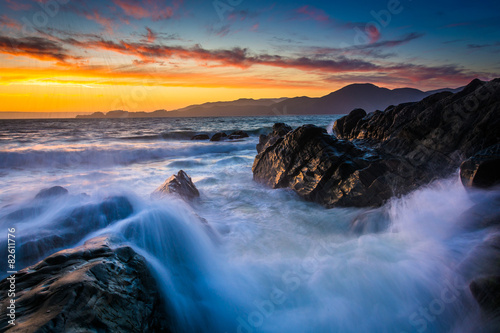 Waves and rocks in the San Francisco Bay at sunset, seen from Ba