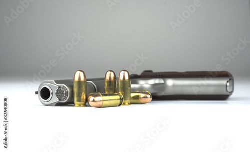 Pistol 1911 and bullets on white background