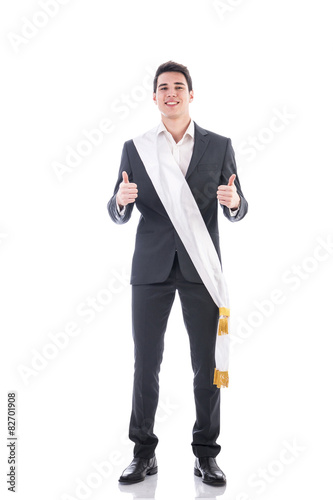 Young elegant man wearing winning ribbon or sash