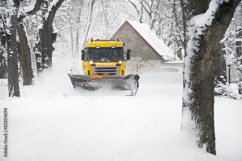 Snowplow Truck Removing the Snow from the village road