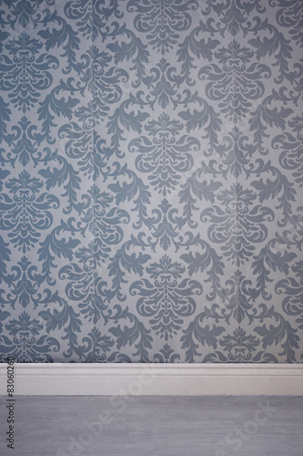 Wall covered by wallpaper with floral pattern