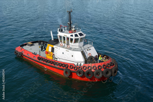 Red tug boat on water