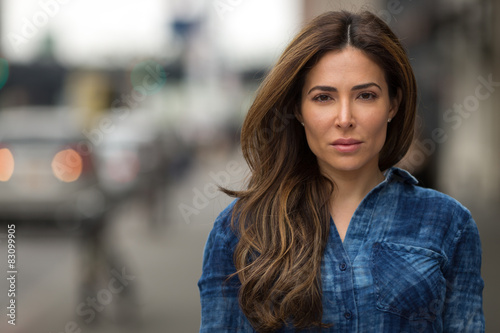 Young hispanic caucasian woman serious face portrait