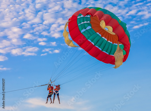 Couple parasailing on the beach