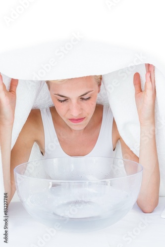 Blonde woman inhaling herbal medicine 