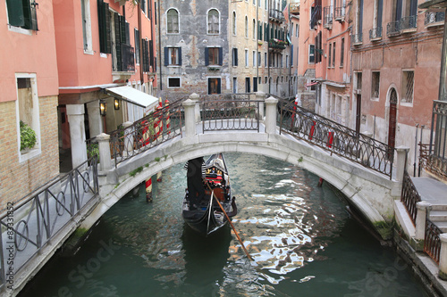 Gondola on narrow canal in Venice, Italy