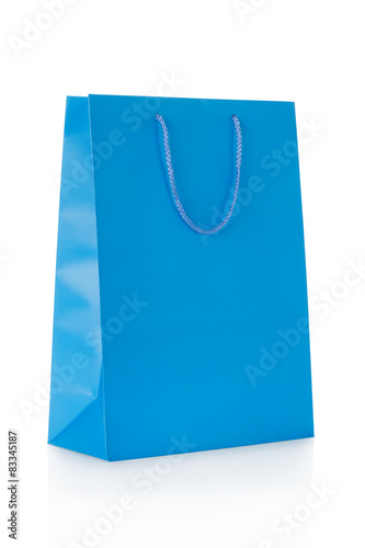 Blue shopping bag in paper isolated on white, clipping path incl