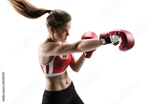 Boxer woman during boxing exercise making direct hit with glove