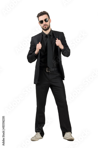 Mysterious man in business suit and white sneakers