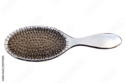 Close-up of an used hairbrush viewed from above, isolated