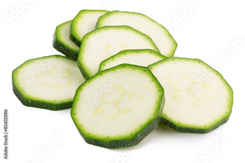slices of green zucchini isolated on white