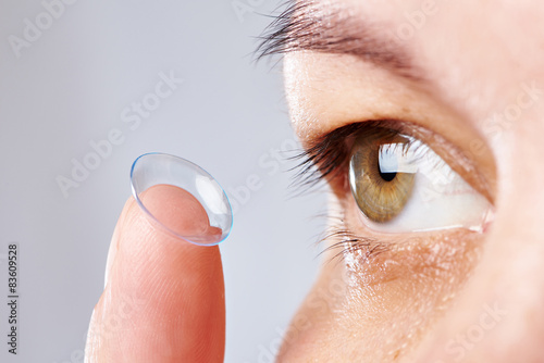 Young womans eye and contact lens