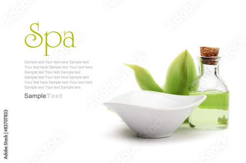 Spa concept. Green orchid, white vessel and spa oil.