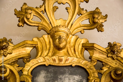 detail of a carved frame of an antique mirror