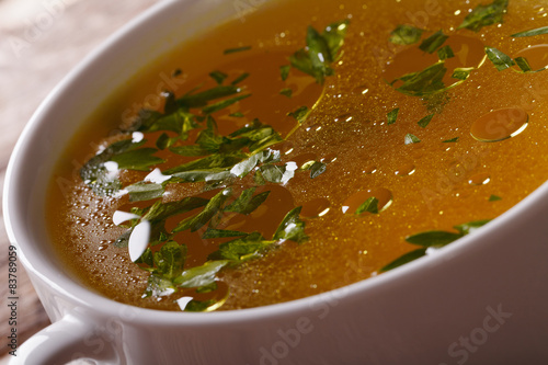 Tasty meat broth with parsley macro. horizontal