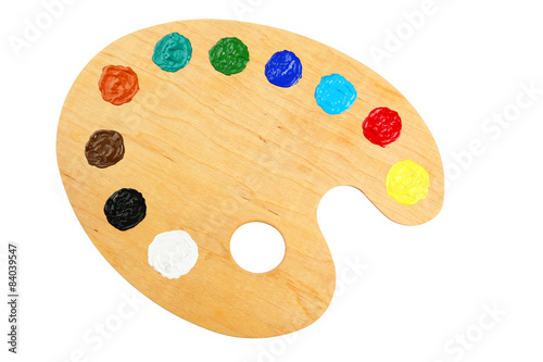 Wooden art palette with paints isolated on white
