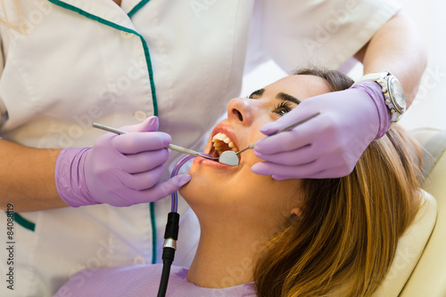 Dentist examining teeth at dental office