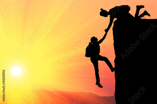 Teamwork couple hiking help each other trust assistance silhouette 