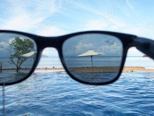 Black sunglasses on the beach.