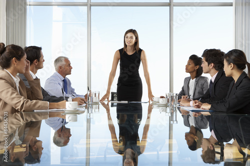 Group Of Business People Having Board Meeting Around Glass Table