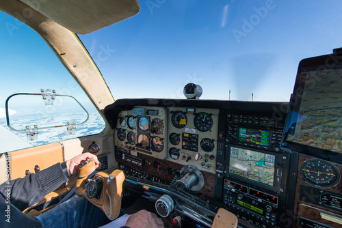 cockpit of old propeller airplane with tablet for navigation