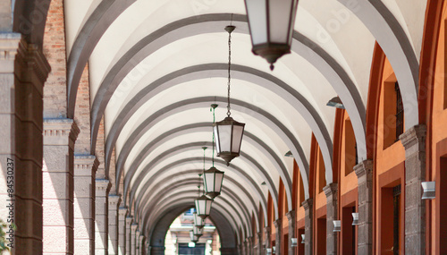Corridor with hanging lamps from the floor.
