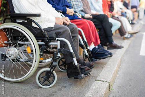 Row of old people in wheel chairs. 