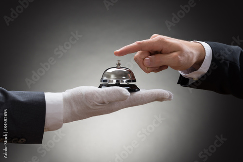Close-up Of A Person's Hand Ringing Service Bell