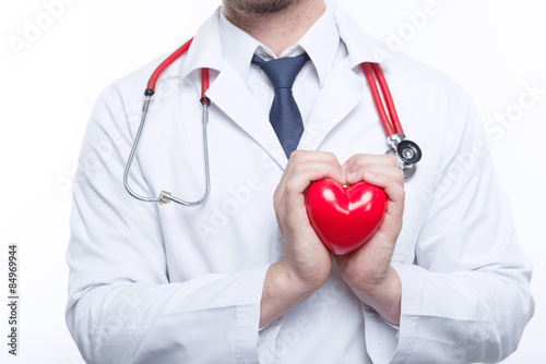 Nice cardiologist holding heart