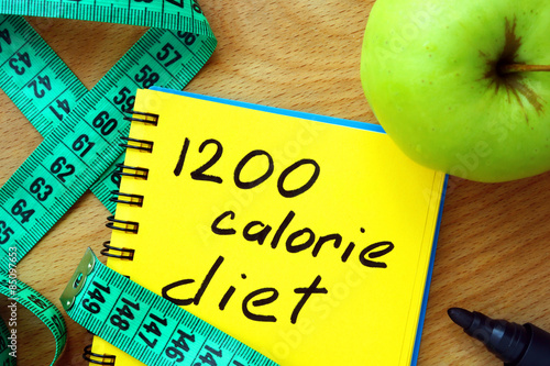 Notepad with 1200 calorie diet, apple and measure tape