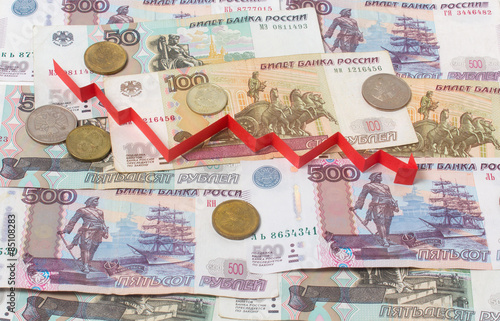 Russian banknotes and arrow down. Currency and Finance